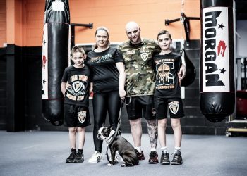 Adelaide Boxing Turner Gym Turner family with a dog posing in front of a boxing bags.