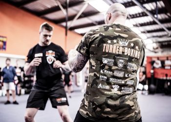 Adelaide Boxing Turner Gym Two men sparring in camouflage t - shirts practicing martial arts.